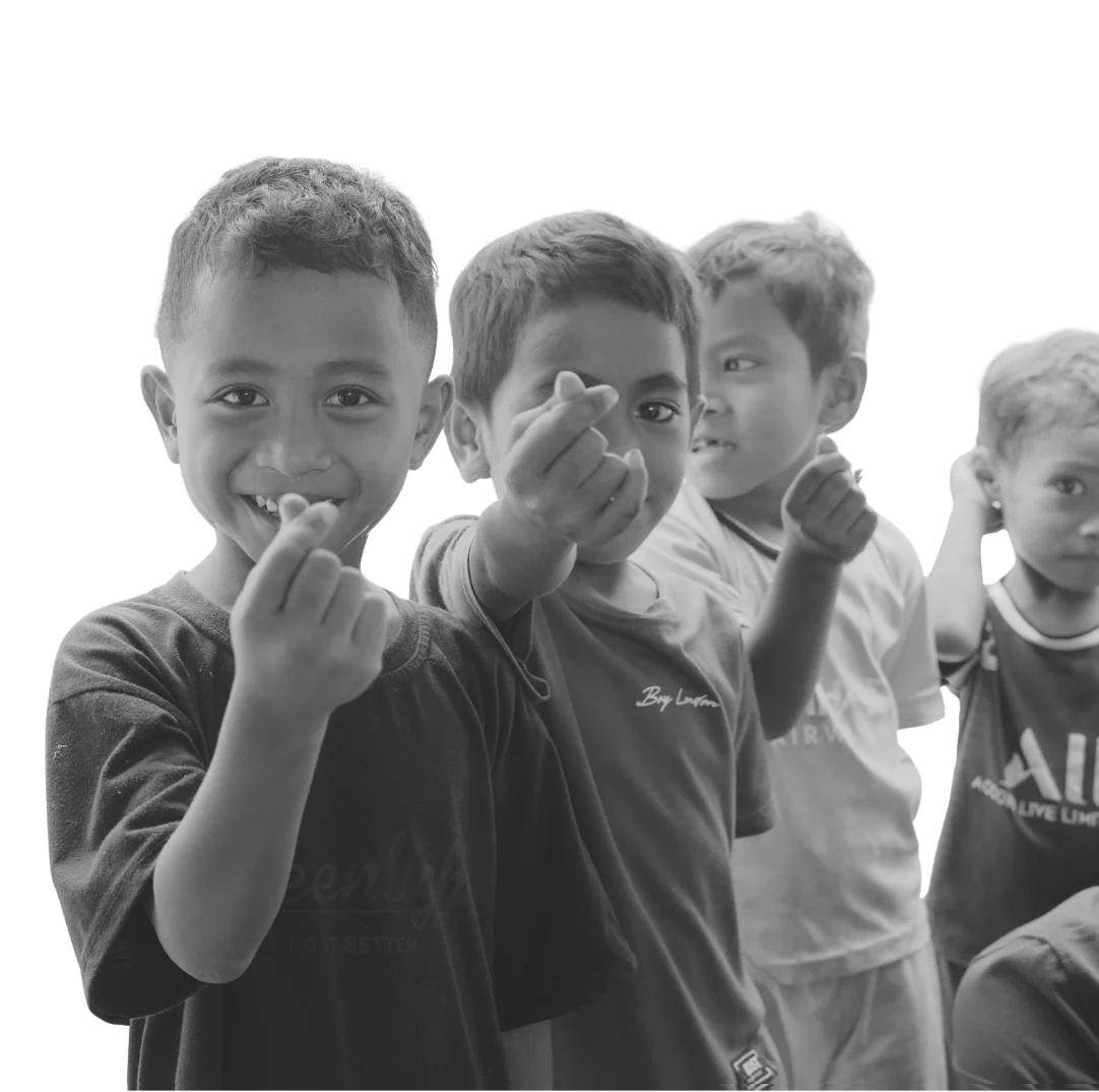 Four children in Flores, smiling at the camera